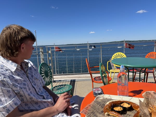 Finn and I sitting amongst the red, orange, yellow, and green chairs of Memorial Union by Lake Mendota.
