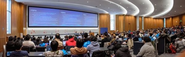 MadHacks judging session with 417 hackers seated in a large lecture hall watching presentation slides about judging on a wide screen.