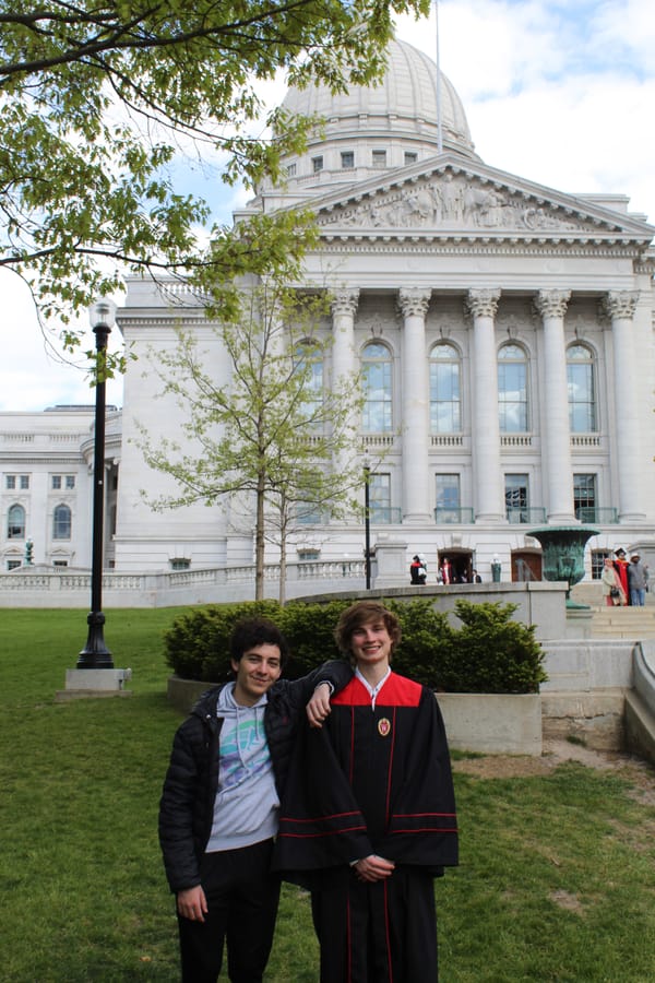 Andrew and I posing on the lawn in front of the Wisconsin State Capitol, with me wearing UW-Madison graduation regalia.